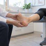 Foot Doctor examining patient foot
