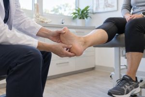 Foot Doctor examining patient foot